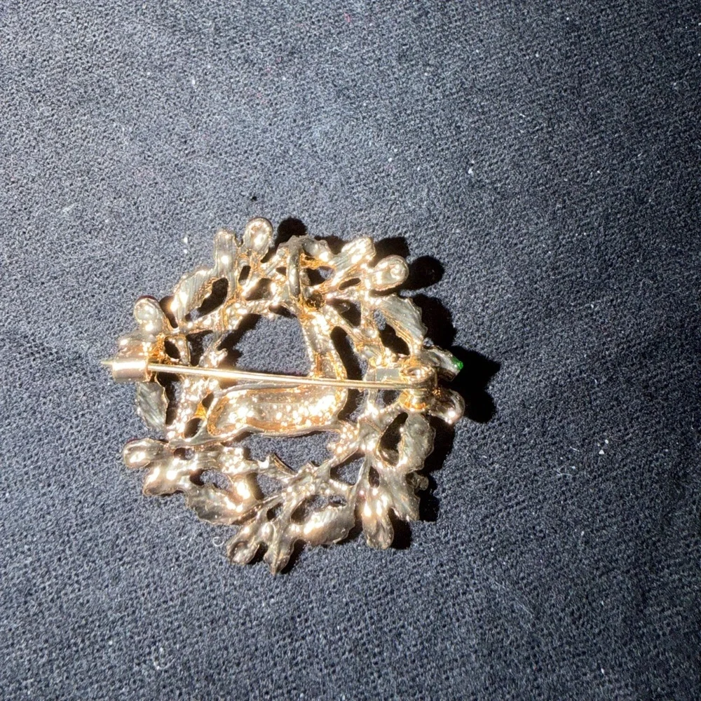 Elegant Gold Reindeer Brooch with Green and Red Accents
